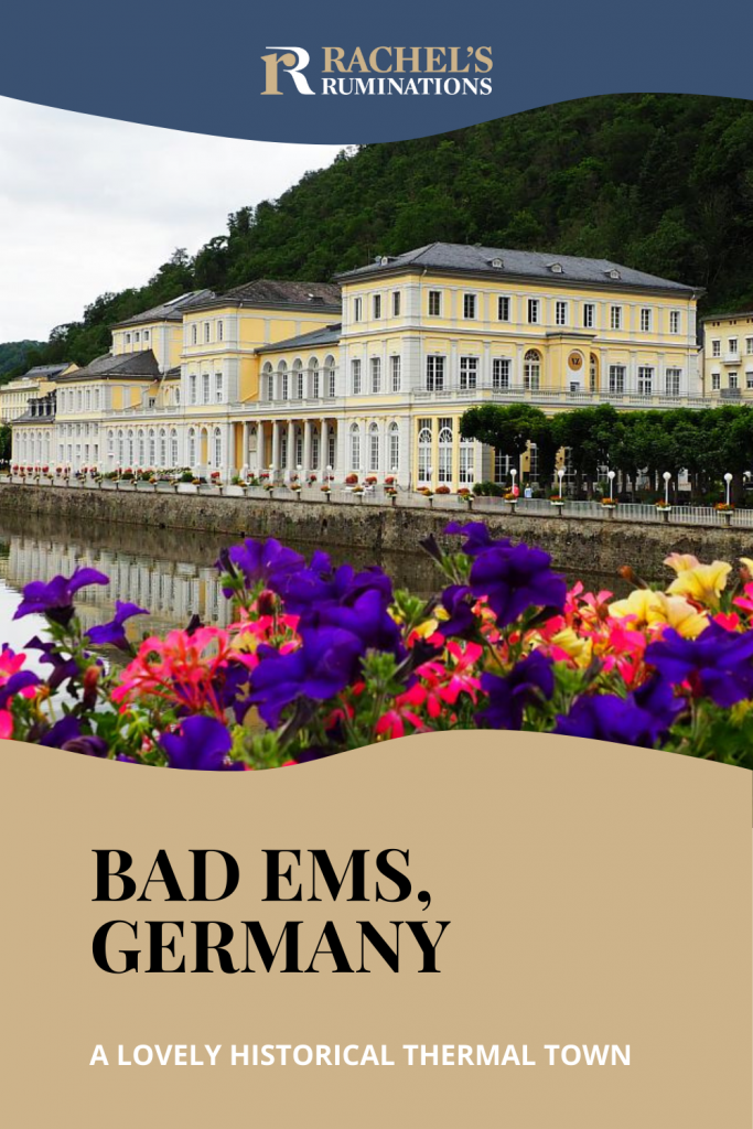 Text: Bad Ems, Germany, a lovely historical thermal town (and the Rachel's Ruminations logo). Image, looking down the river at the Kurhaus, with a row of bright flowers in the foreground.