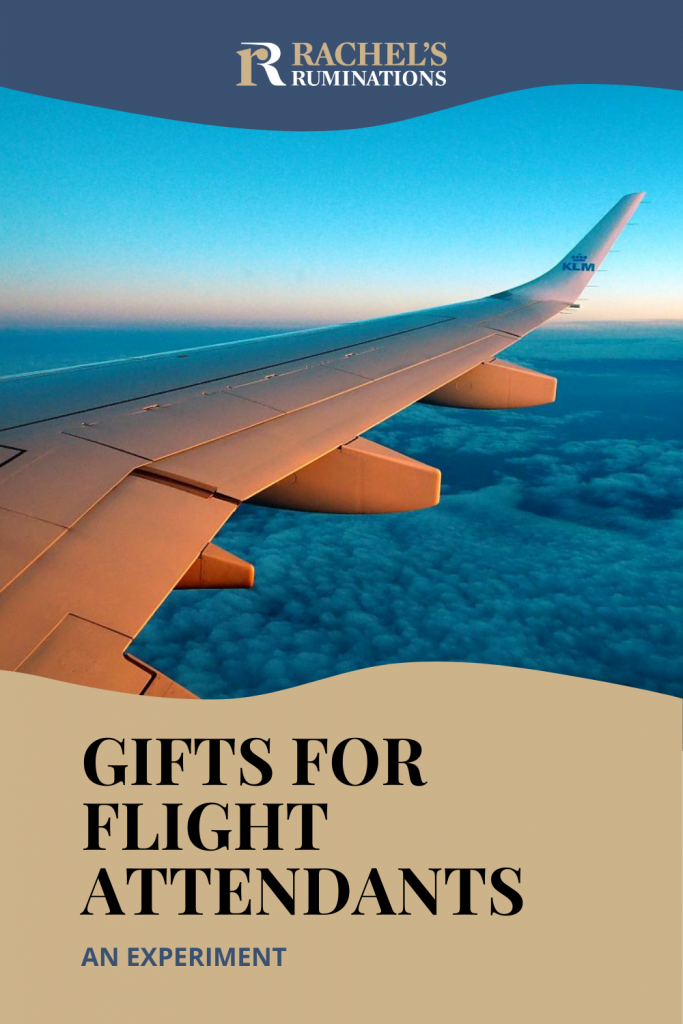 Text: Gifts for Flight Attendants: An experiment. Image: view out an airplane window over the wing, flying over clouds with a sunset or sunrise tinge to the horizon.