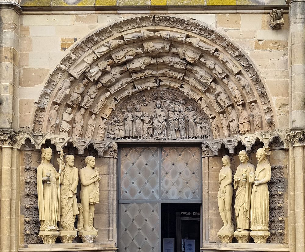 Over the door of the church is a bas-relief of the Madonna and child and saints. On either side of the door are 3 statues, presumably also saints (though one appears to be a naked woman). IN the carved arch extending over the door from one line of statues to the other are lots more images of saints.