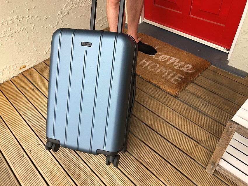 A grey metallic hard-sided carry-on bag with wheels.