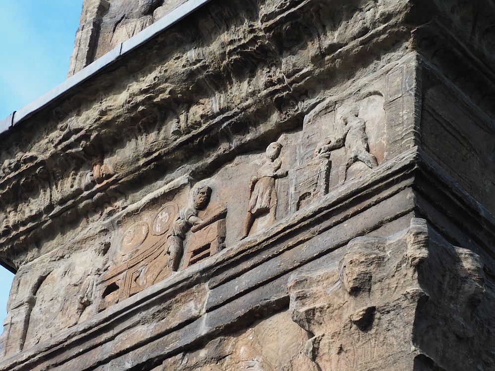 The bas-reliefs seem to show people at work: One seems to be working on something at a table, while two more are doing something with what looks like a fireplace.