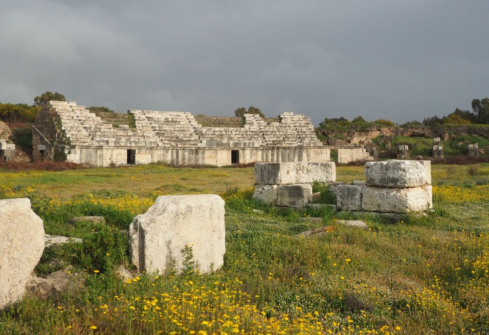 The stands in the background: white stone rising in rows of benches. 