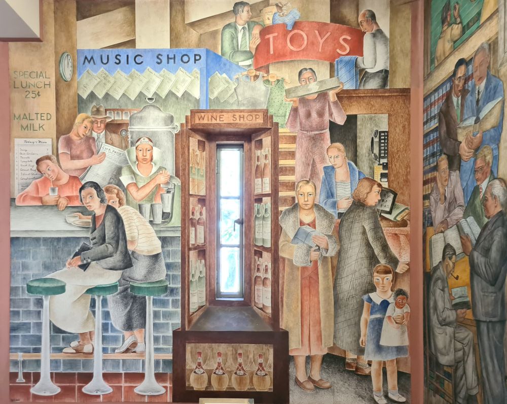 A narrow window in the center, painted with wine bottles on shelves around it. Left, women sit at a lunch counter, people behind the counter read a paper or serve food. Right, shoppers carrying various items, a white girl holding a dark-skinned doll.