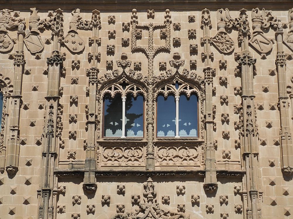 Stone carvings stand out from the flat surface of the building: most are not figurative but rather floral. 