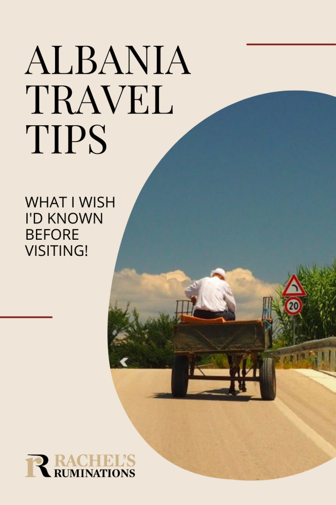 Pinnable image
Text: Albania Travel Tips: What I wish I'd known before visiting!
Image: seen from behind, a man on a horse-drawn cart on a paved road.