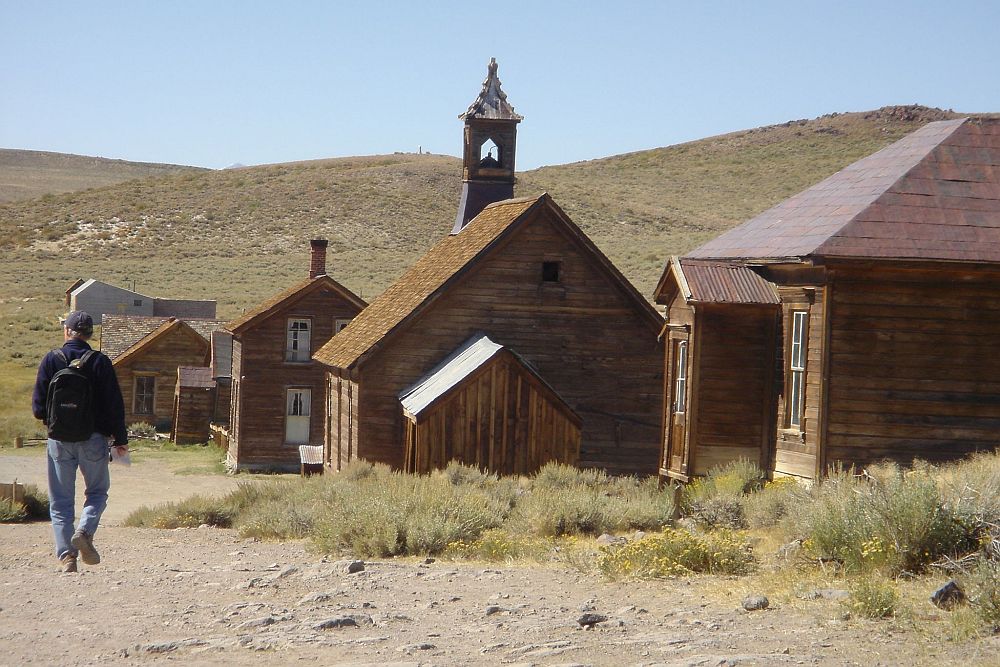 A row of brown wooden buildings down a slight slope at Bodie, a California ghost town.