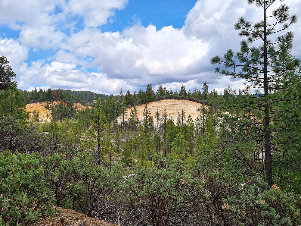 A view over a valley, with exposed rock sides and small trees in the bottom of the valley. Malakoff Diggins, one of the ghost towns in California.