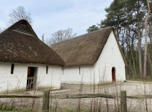 Two small and tidy simple buildings. White plaster walls, peaked thatched roof. A single door in the near end of each and a few very small windows.