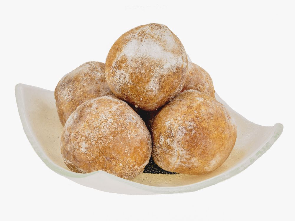 round balls, off-white, with a sprinkling of powdered sugar, piled in a plate.