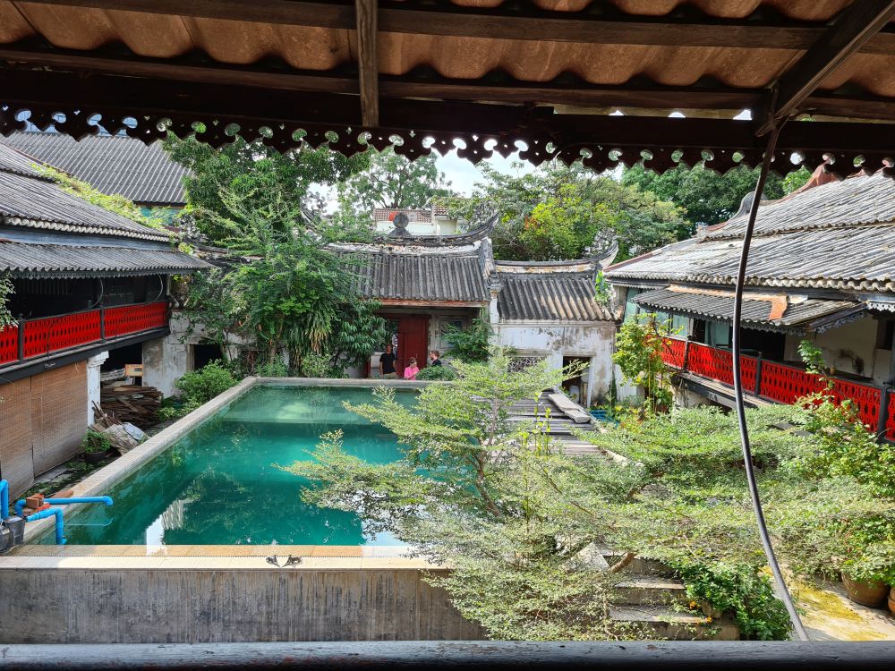 The house is U-shaped; this photo faces the entrance and shows the two side wings of the house, plus the former courtyard, now filled with a pool.