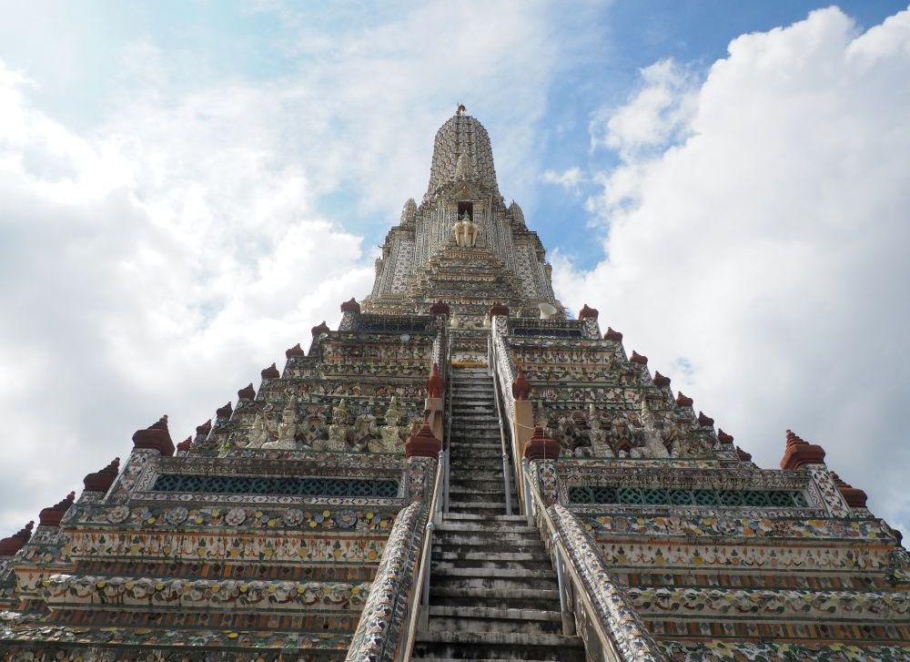 Looking up the stupa: a stairway up the middle, very steep, and tiers like a wedding cake, smaller and smaller toward the top, all of it covered with flowery patterns of ceramic tiles.