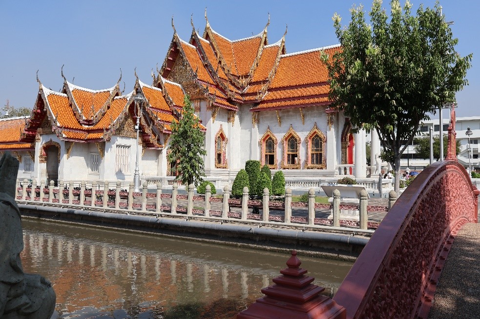 A pretty temple with white walls and red-tile roof.