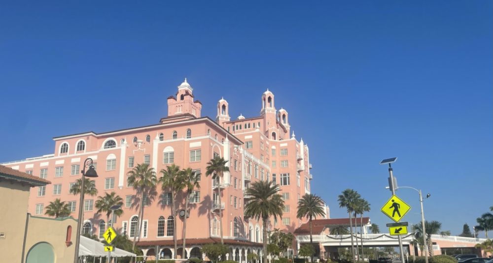 The hotel is about 6-7 stories and pastel pink, with several turrets.