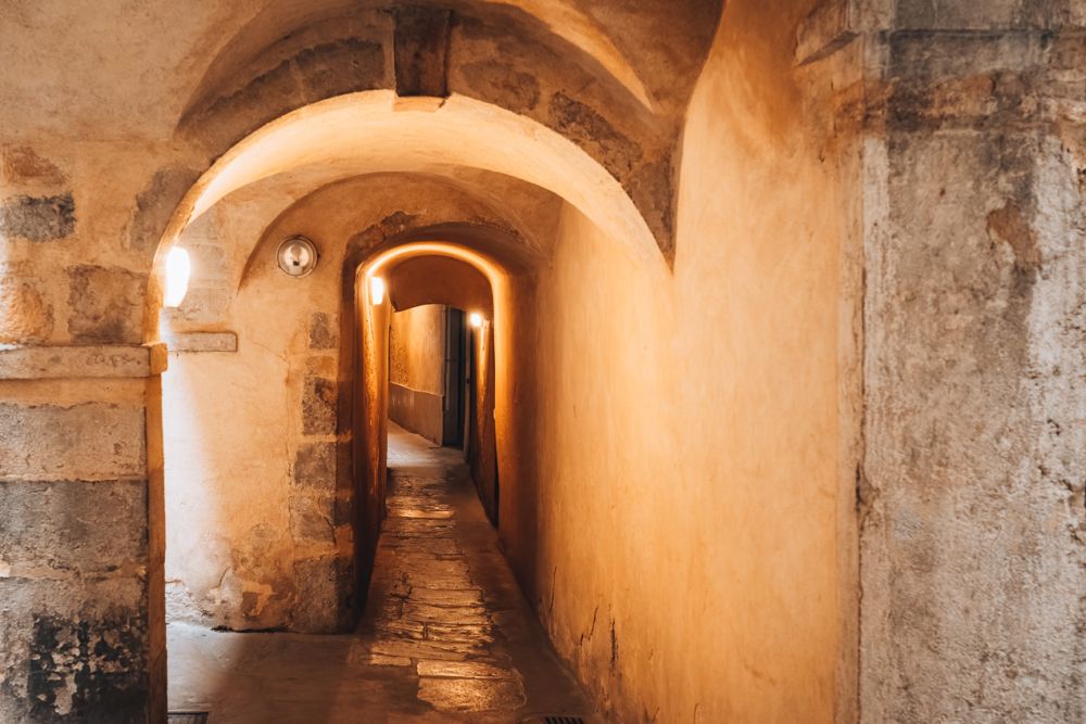 An arched passageway with daylight coming from the side.