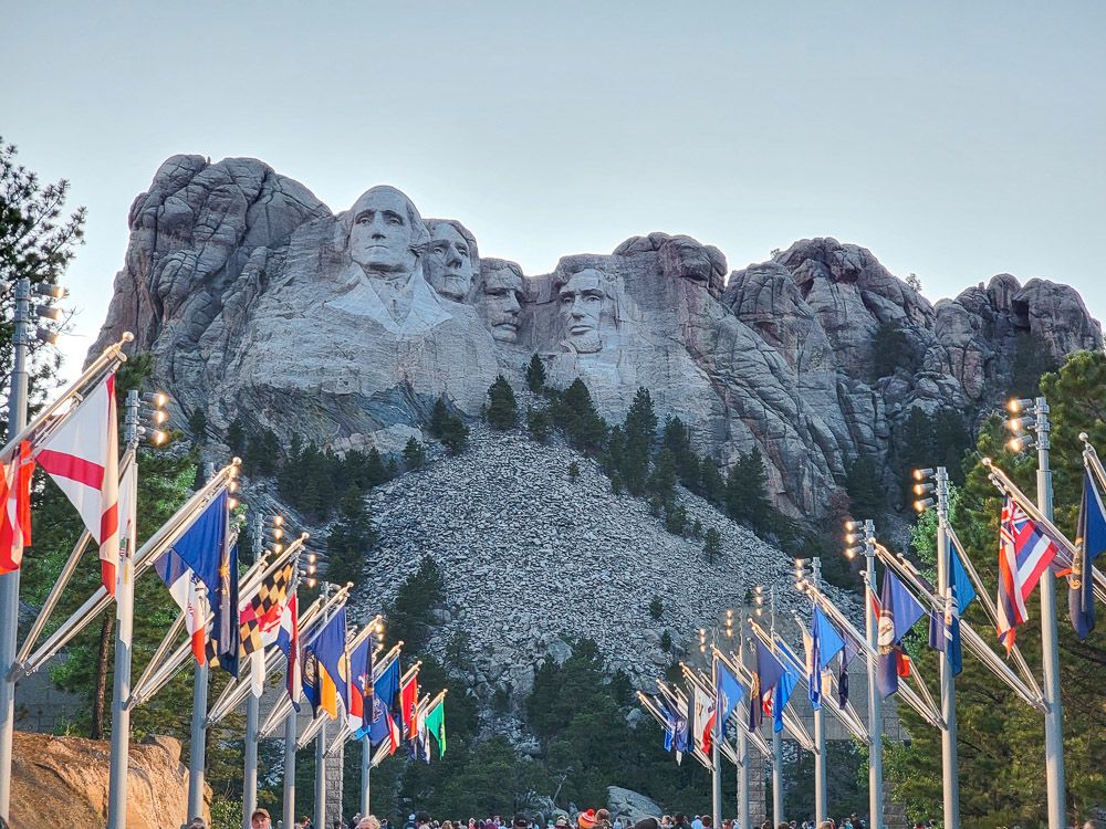 The Avenue of Flags: flags lining the path that leads straight to the image of the presidents on the mountain.