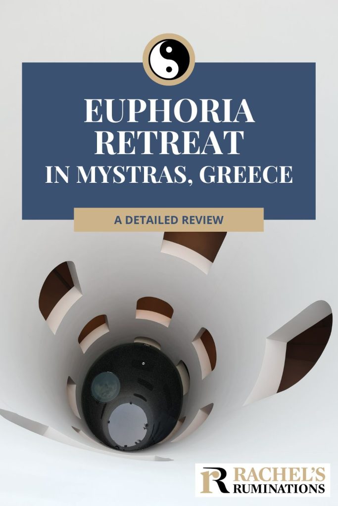 Text: Euphoria Retreat in Mystras, Greece: A detailed review. Image: Looking down a cylindrical tube with windows here and there in the sides.