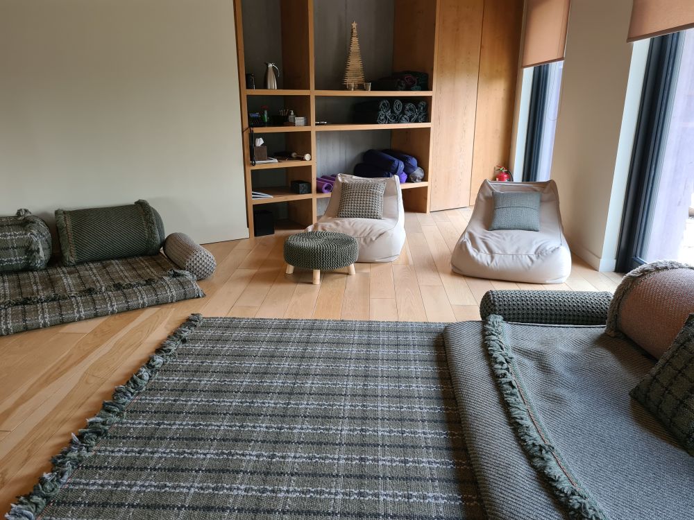 Low carpets and low futon-type seats on a blond-wood floor.