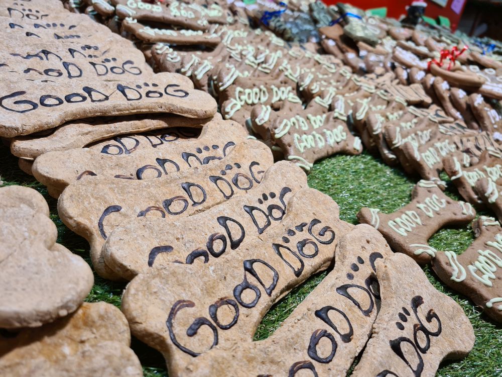 Dog biscuits shaped like bones and with the words "Good Dog" written on them.