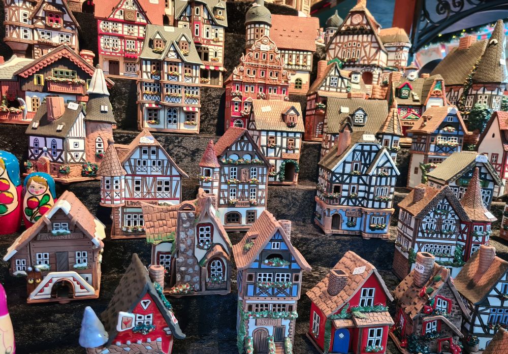 In stepped rows, so they call can be well seen, a range of different shapes and sizes of porcelain houses, most in a typical German half-timbered style, each painted and decorated differently.