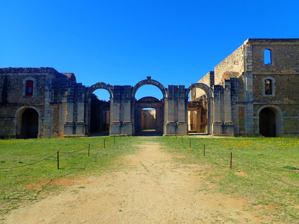 A flat path straight ahead, and the fortress, with open arches and partially in ruin. 