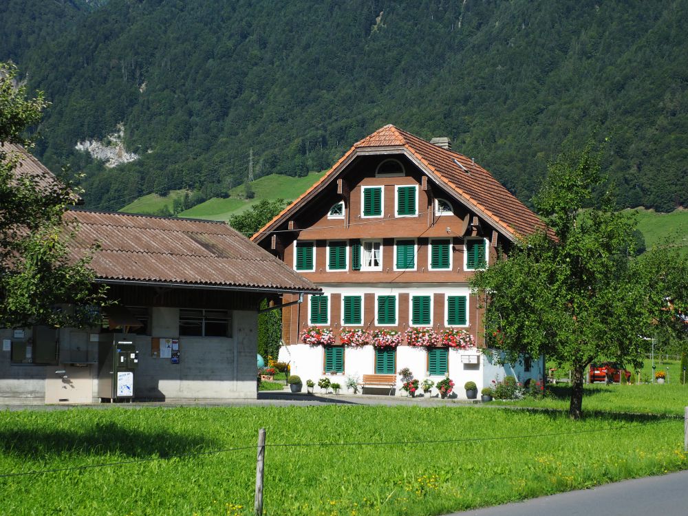 A typical chalet: wooden on a stone base with lots of windows and a peaked roof.