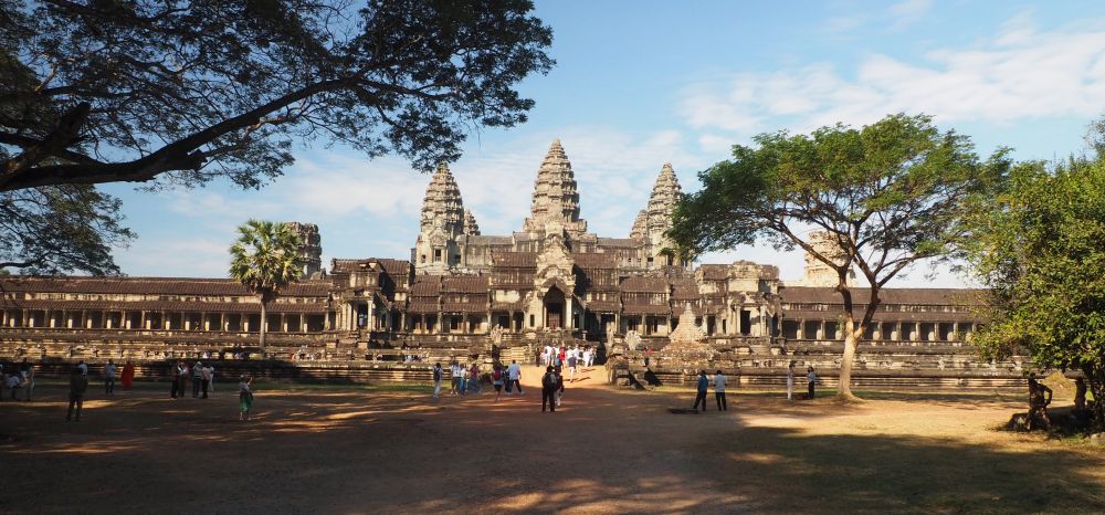 A very wide imposing building with 3 towers