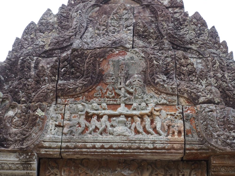 An intricate stone carving with many figures in it.