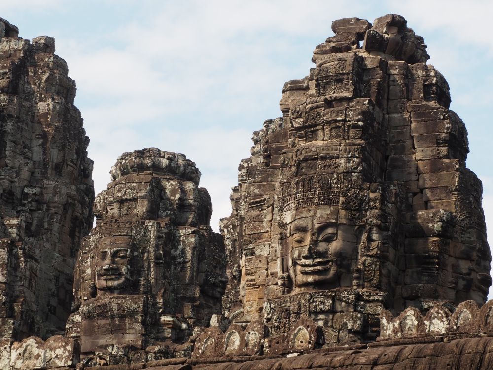 The towers have huge Buddha faces carved into them.