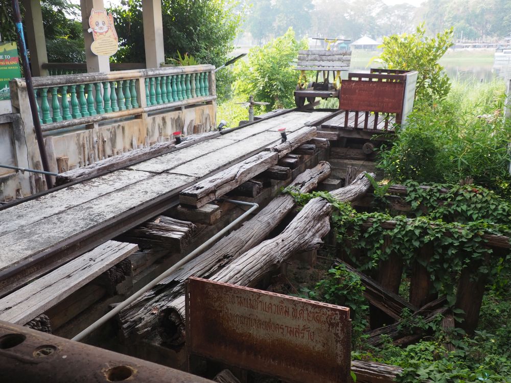 A length of rail on a wooden bed, and with large poles supporting it underneath.