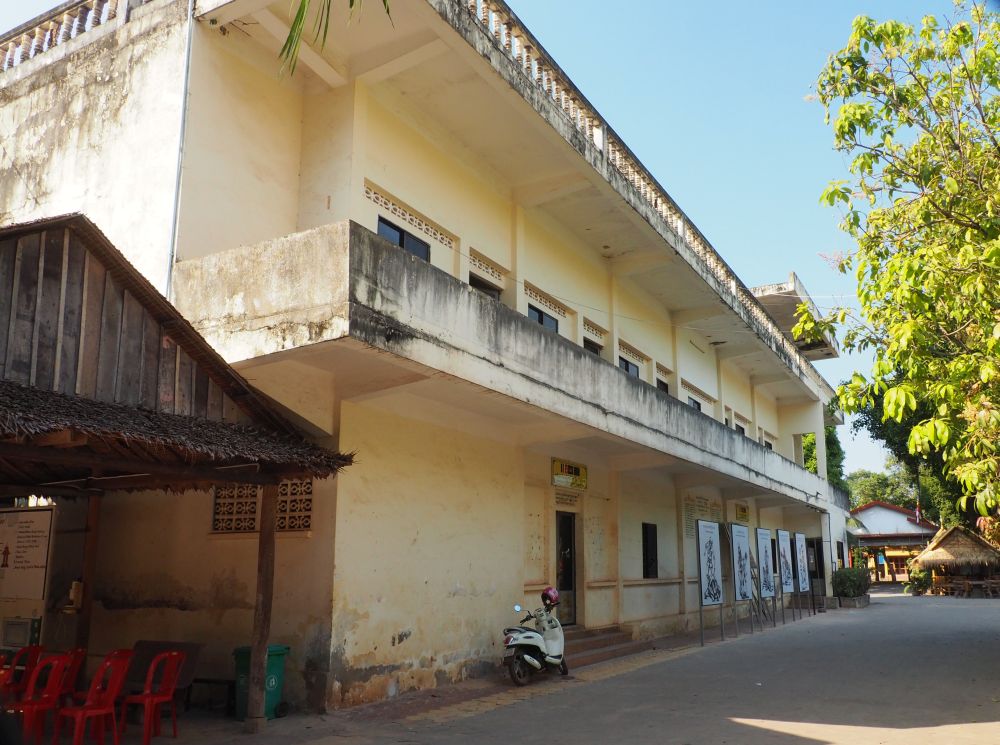 A two-story building with a balcony the length of its upper floor.