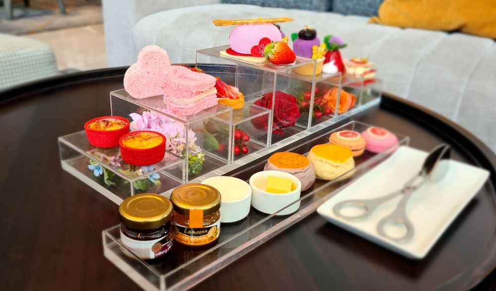 Two long trays with an array of small items at afternoon tea at Carlton Hotel Bangkok Sukhumvit.