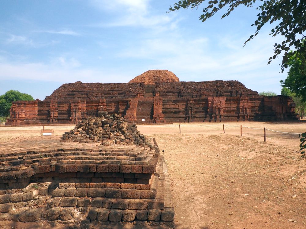 A large platform with sides at a diagonal and a flat top, made of large stones. 