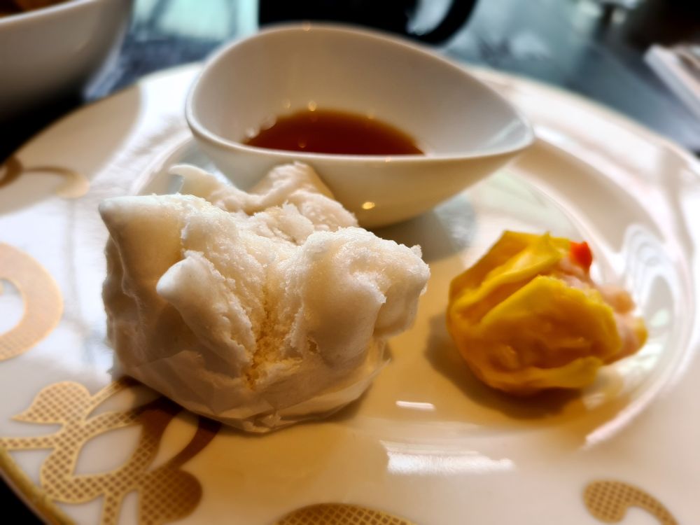 Two dim sum items on a plate.