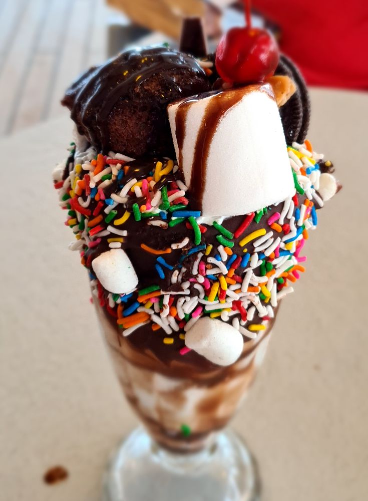 A sundae coated with sprinkles, marshmallows, chocolate, syrup and a cherry. A "specialty" ice cream on Princess cruises.