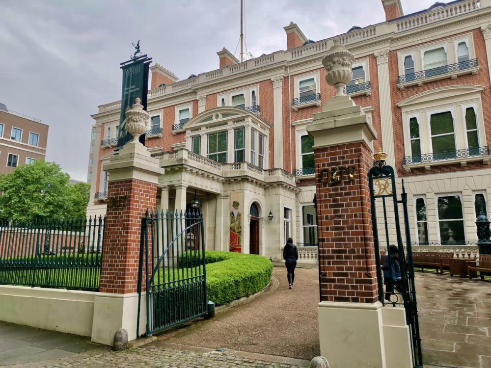 A grand entrance to a stately brick building with white stonework around the windows.