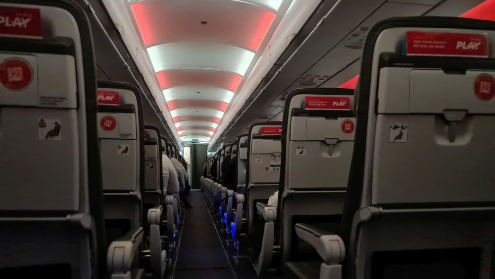 View looking down an airplane aisle.