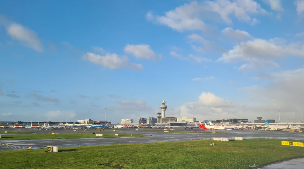 runway and in the distance the airport building and control tower.