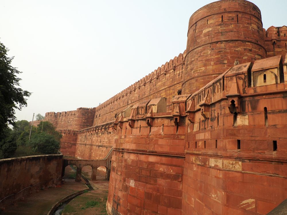 A red sandstone fortification - thick walls in several levels, with a moat.