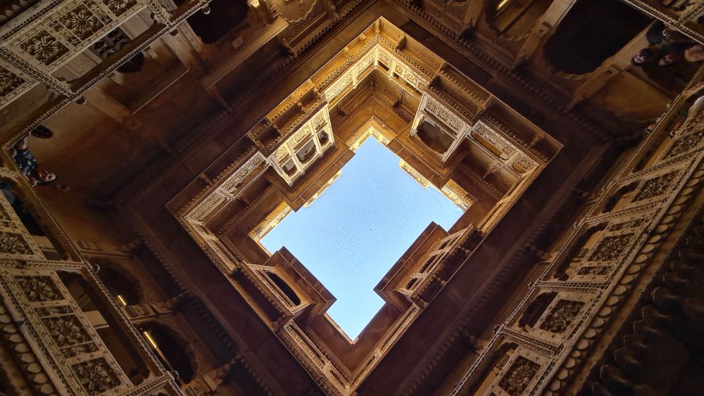 Looking up to the sky in a rectangular lightwell.