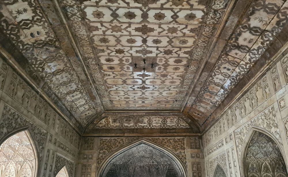 Highly decorated ceiling and walls with floral patterned inlays.