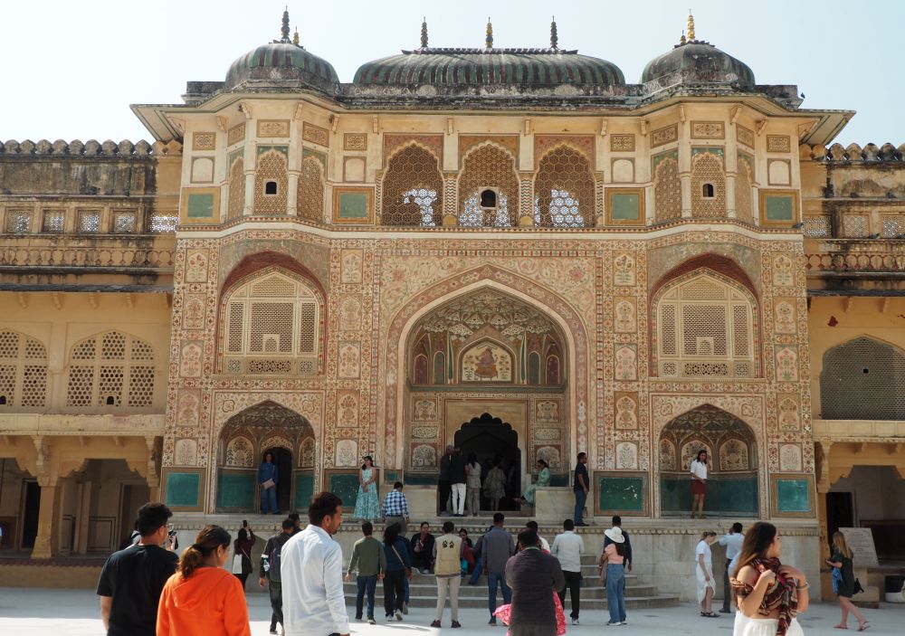 A large ornamental gateway, covered in detailed paintwork, with a large archway in the center.