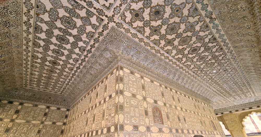 A corner of two walls and the ceiling outside of it, all covered with detailed geometric shapes.