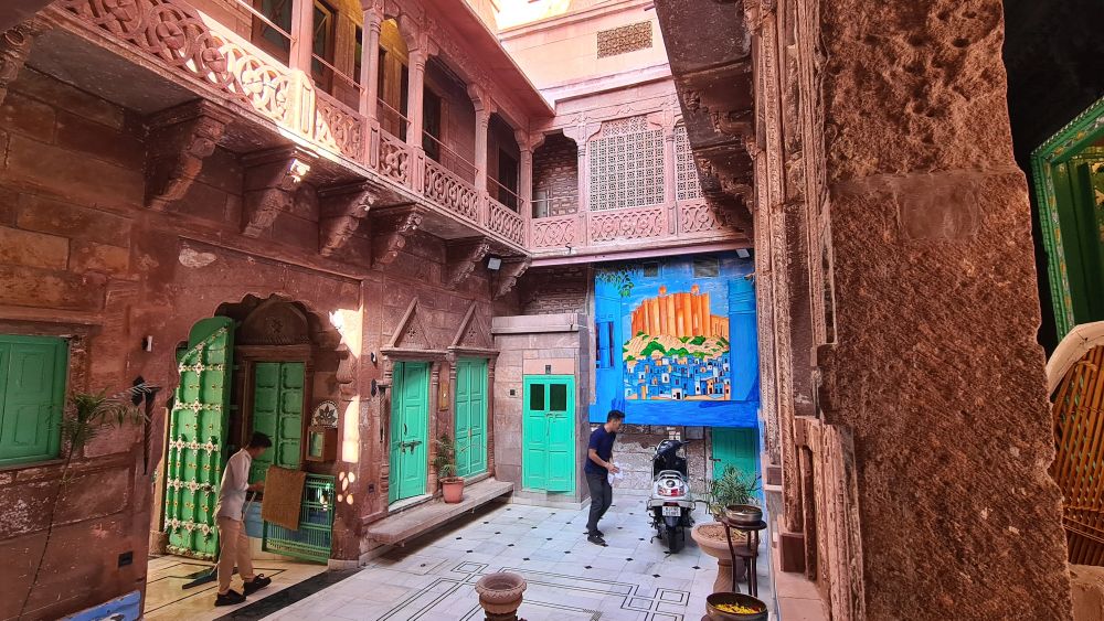 A courtyard with balconies on the floor above it. Lots of pretty stonework.