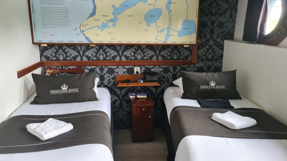 Two single beds with a small bedside table between them.