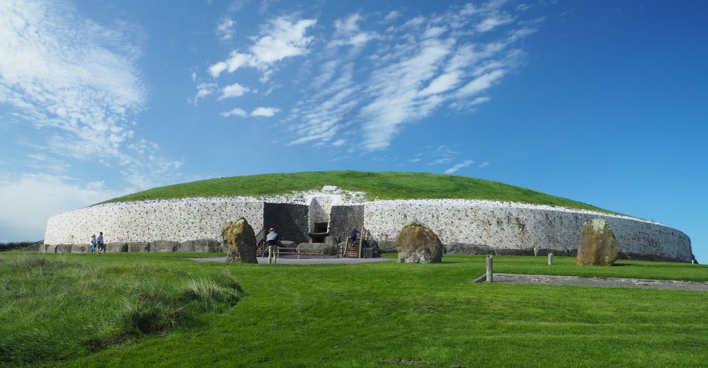 The mound is sided with white stones and the original spaces stones line the bottom of the white walls. The top is grass-covered.