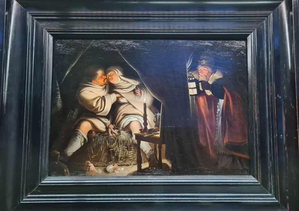 A monk and nun embrace passionately - a bit of her breast is revealed. Another man peeks at them, holding a lantern.