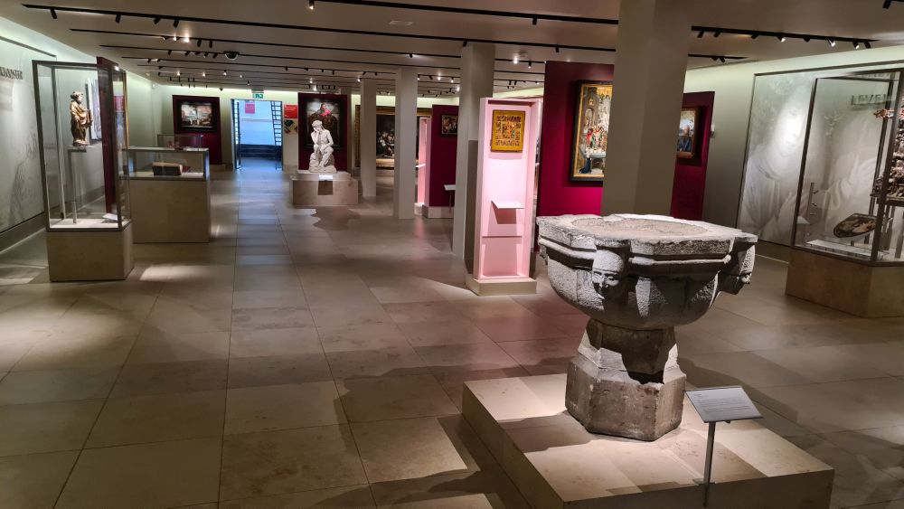 A view across a gallery dotted with paintings and sculptures at Museum Catharijneconvent