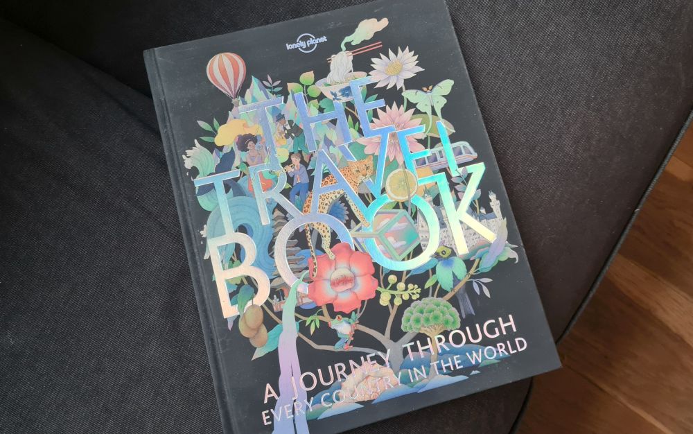 A hardcover book called "The Travel Book: A journey through every country in the world."