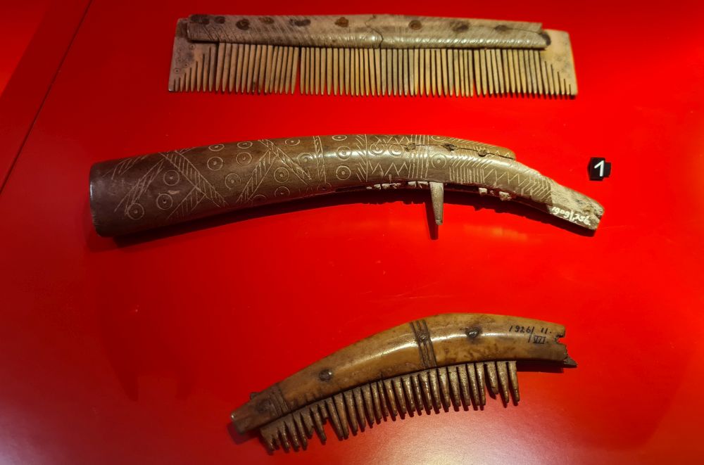 3 carved combs. The top and bottom ones still have their teeth; the middle one doesn't.