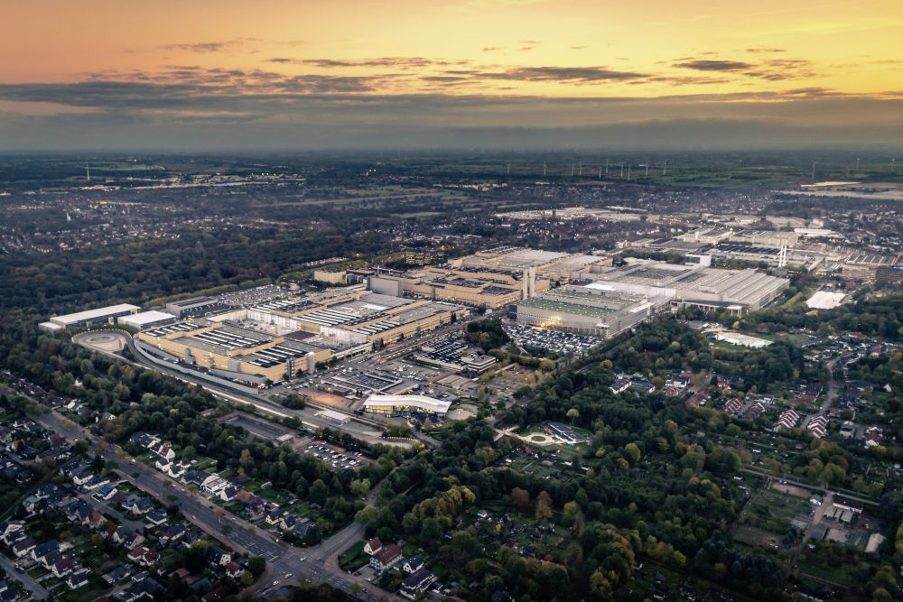 Sunset view over a very large area of big buildings, with what look like tiny houses in rows around its edges.